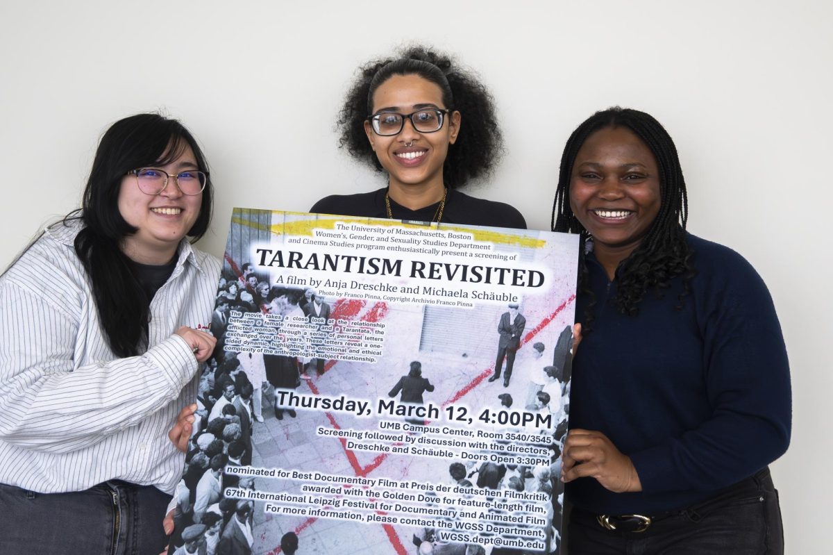 Students pose with the poster for a screening of "Tarantism Revisited."