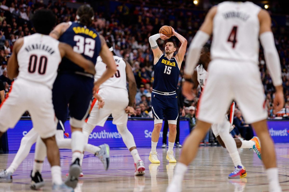Apr 6, 2026; Denver, Colorado, USA; Denver Nuggets center Nikola Jokic (15) attempts a shot as Portland Trail Blazers center Robert Williams III (35) and forward Aaron Gordon (32) and guard Scoot Henderson (00) and guard Matisse Thybulle (4) look on in the second quarter at Ball Arena. Mandatory Credit: Isaiah J. Downing-Imagn Images