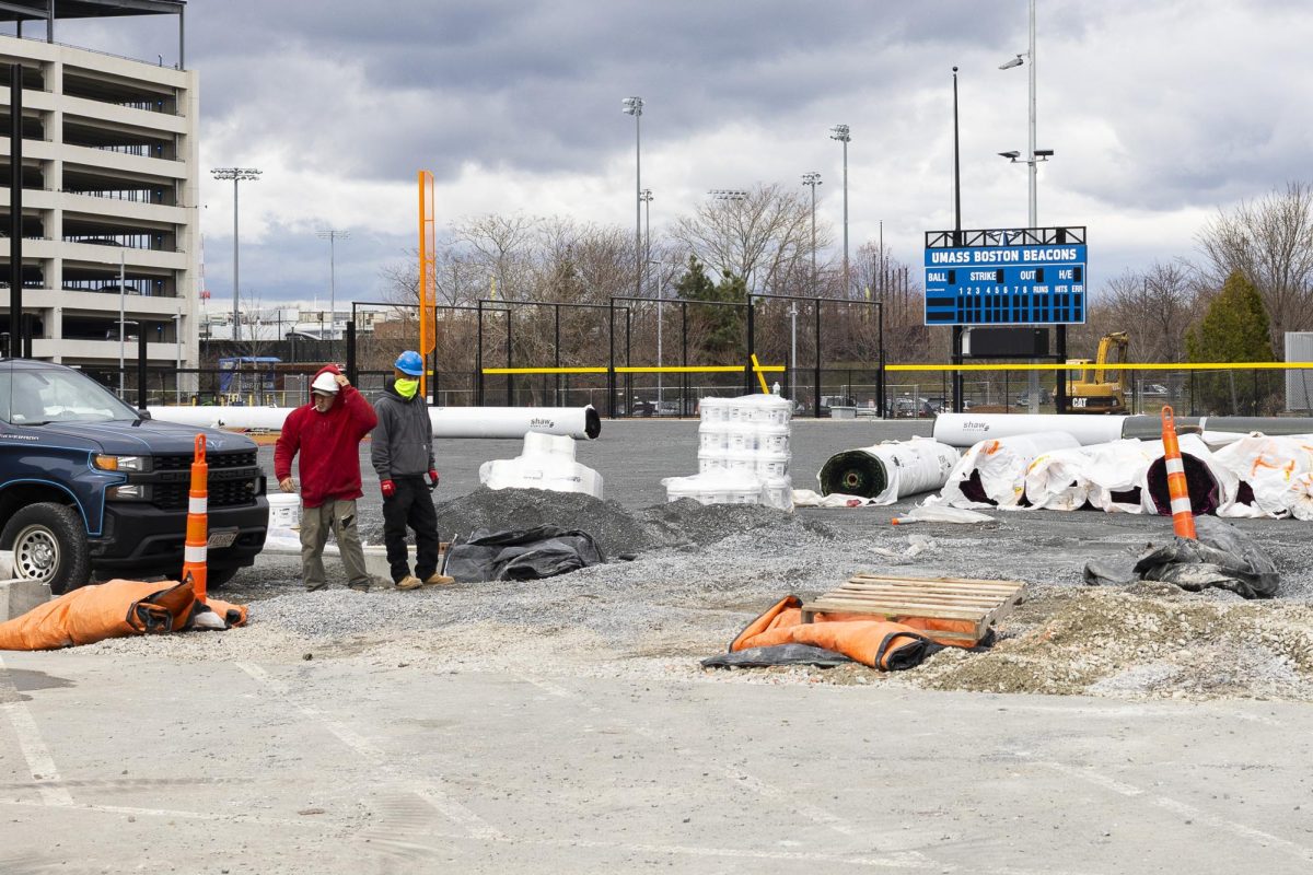 Construction workers prepare to lay turf at the softball field outside the 
Clark Athletic Center March 27. EJ Bunjo for The Mass Media