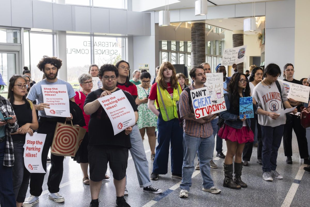 Students, staff and faculty were represented at the rally, holding signs reading "Stop the Parking Rate Hikes!", "Don't Cheat the Students", and "Bring Back a Multi-use Pass 'For the Times.'" 