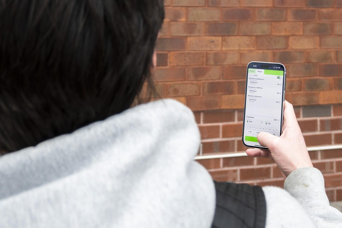 An underage student places bets on the Fliff app, utilized by many for its loopholes that enable sports gambling under 21. Photo illustration